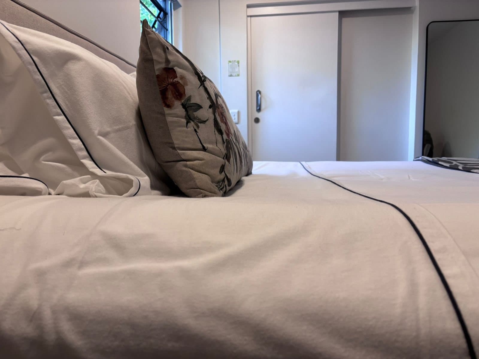 Bed made up with a white cotton sheet set and pillows, from the C4G bed linen range
